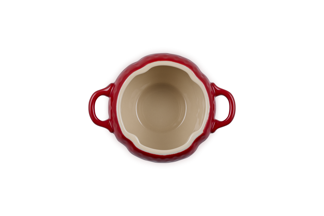 Red ceramic dish with handles on a white background