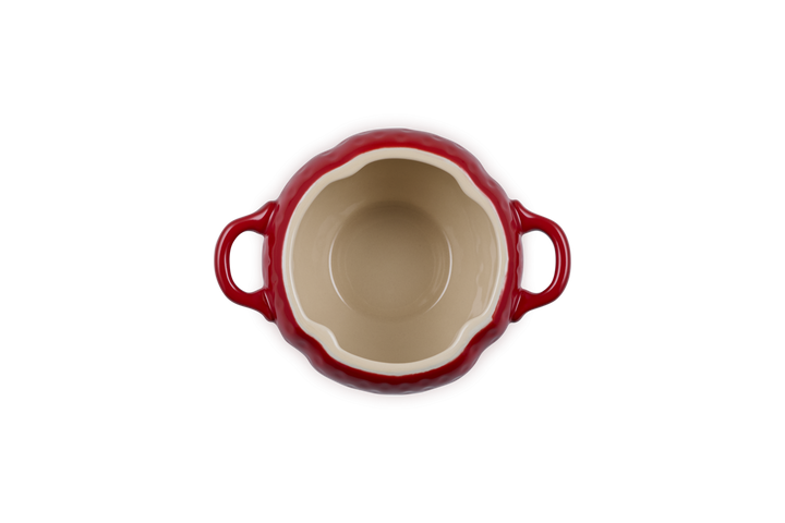 Red ceramic dish with handles on a white background