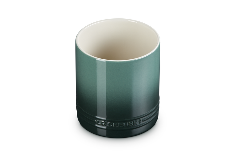Green ceramic utensil jar with Le Creuset branding on a white background