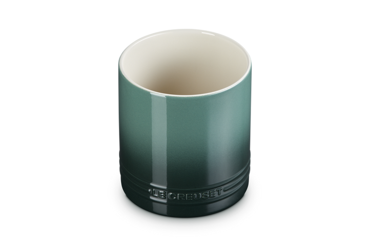 Green ceramic utensil jar with Le Creuset branding on a white background