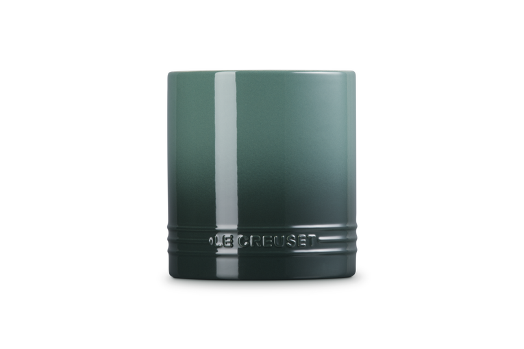 Green utensil jar on a white background