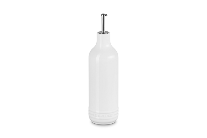White ceramic oil bottle with a silver cap on a white background