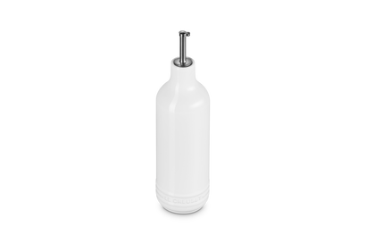 White ceramic oil bottle with a silver cap on a white background
