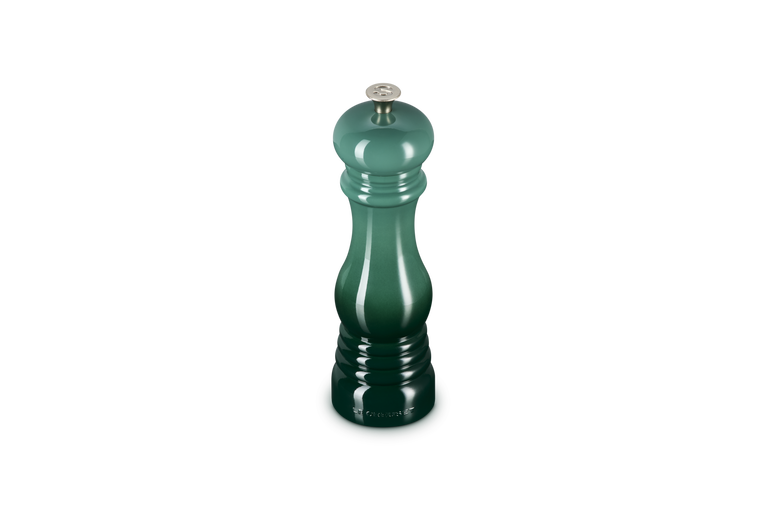 Green pepper grinder on a white background
