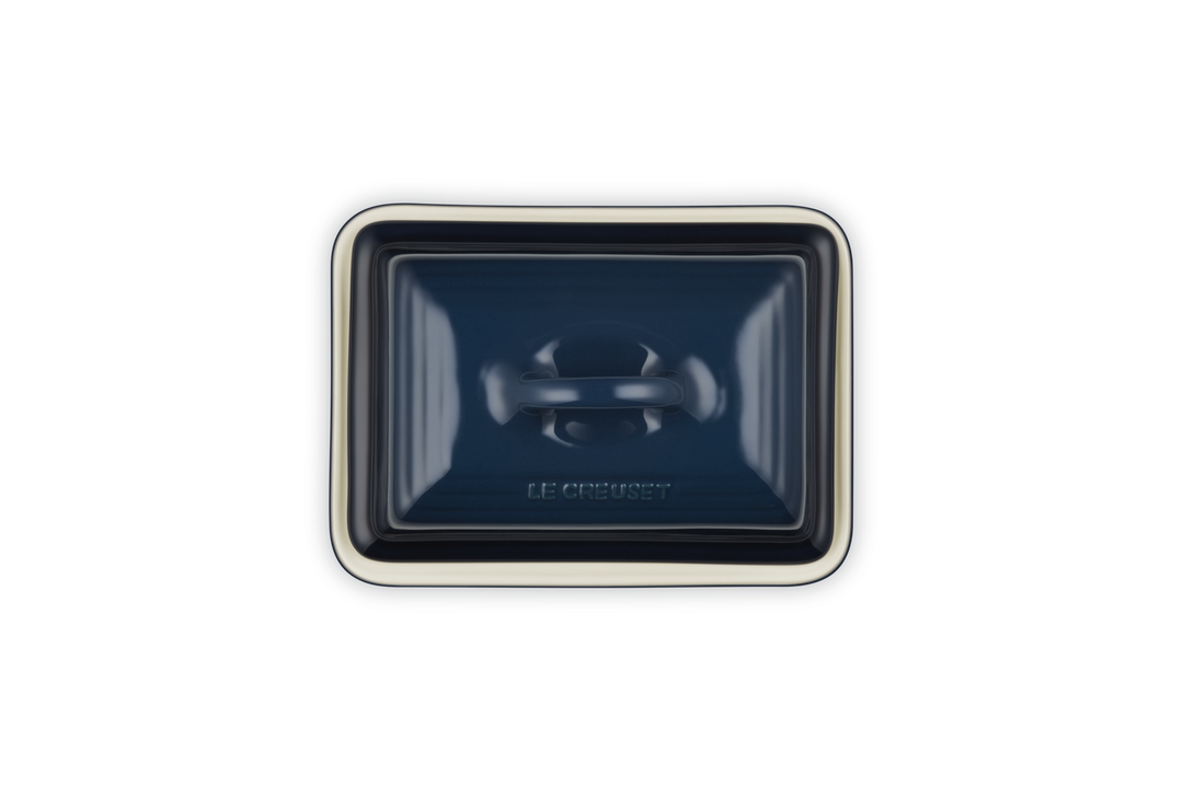 Rectangular blue ceramic butter dish on white background