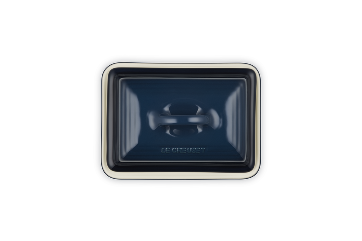Rectangular blue ceramic butter dish on white background