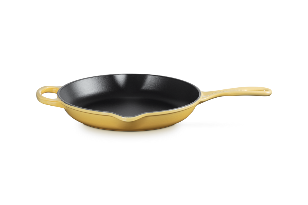 Le Creuset Camomile yellow cast iron skillet on a white background