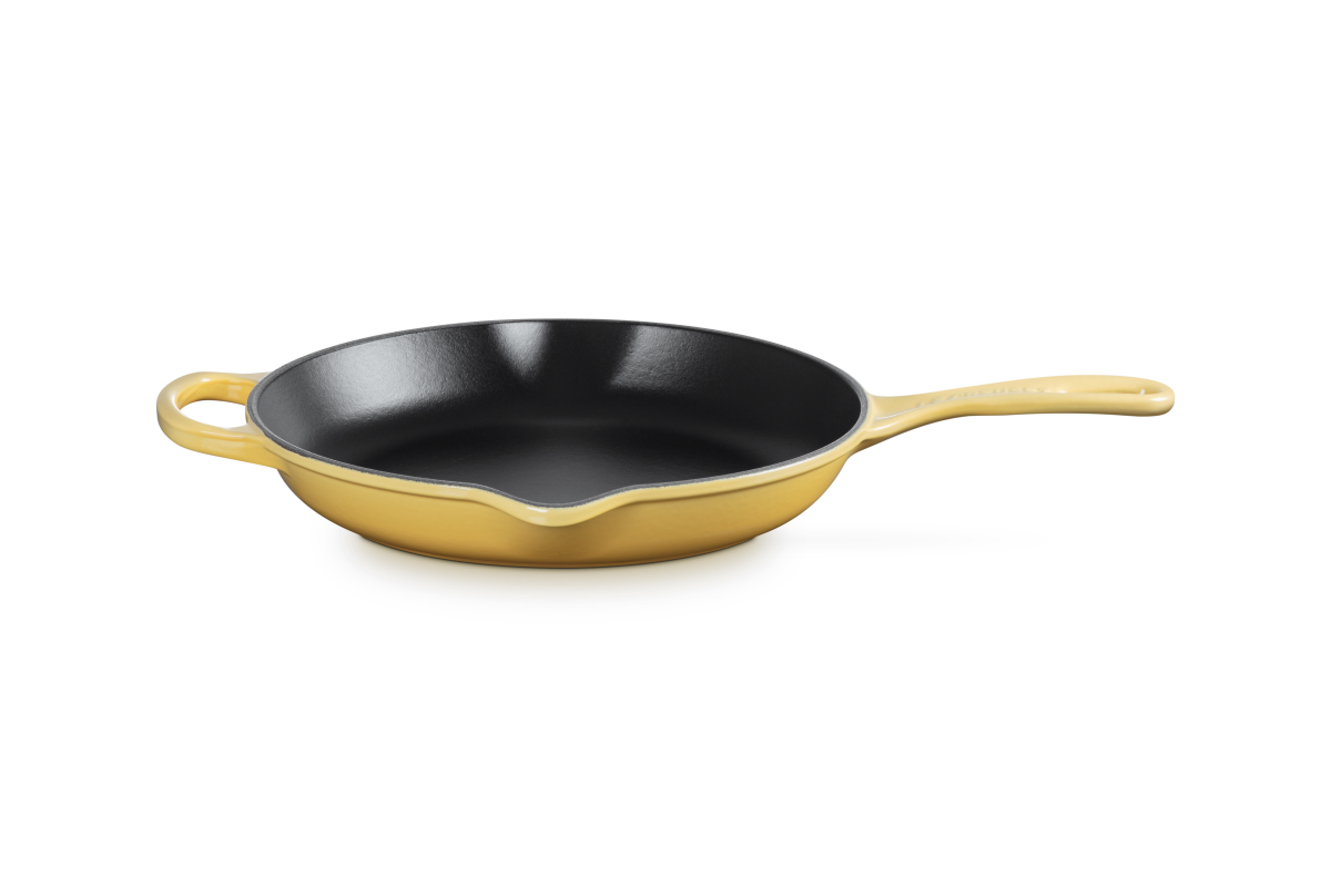 Le Creuset Camomile yellow cast iron skillet on a white background
