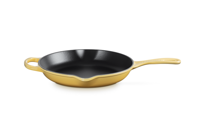Le Creuset Camomile yellow cast iron skillet on a white background