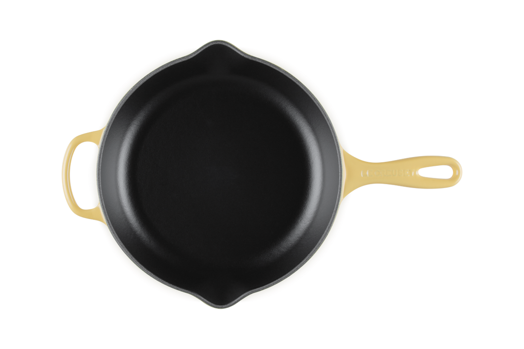 Le Creuset Camomile yellow cast iron skillet on a white background