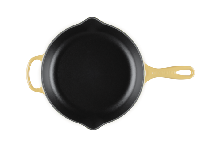 Le Creuset Camomile yellow cast iron skillet on a white background
