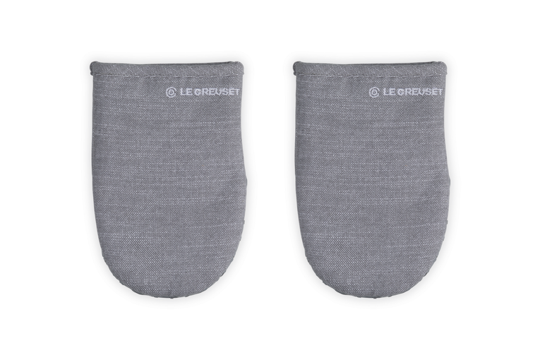 Pair of gray oven mitts with Le Creuset branding on a white background