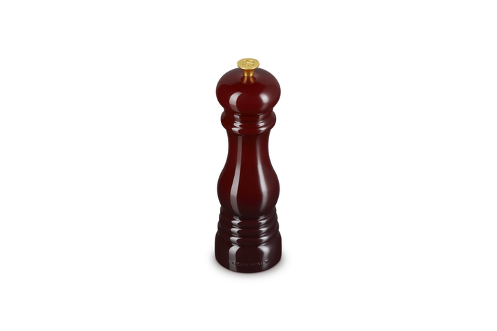 Burgundy salt grinder on a white background