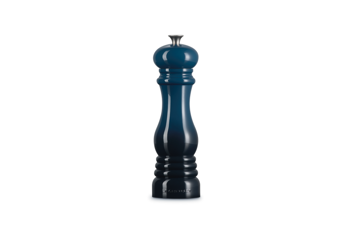 Dark blue salt grinder on a white background