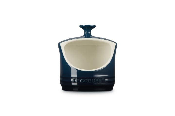 Blue and white ceramic salt pig with 'Le Creuset' branding on a white background