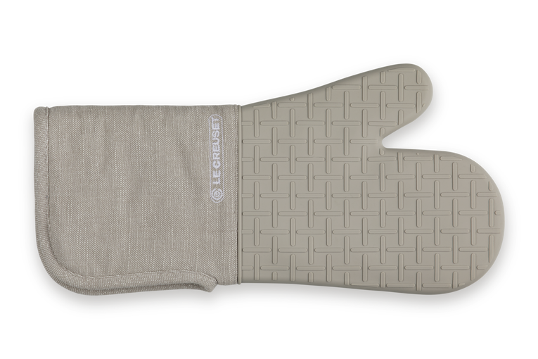 Beige oven mitt with textured surface on a white background