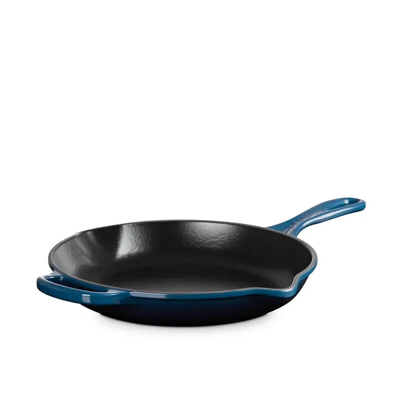 Blue cast iron skillet on a white background