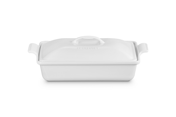 White ceramic baking dish with handles on a white background