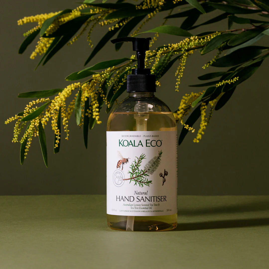 Bottle of Koala Eco hand sanitizer with a plant in the background