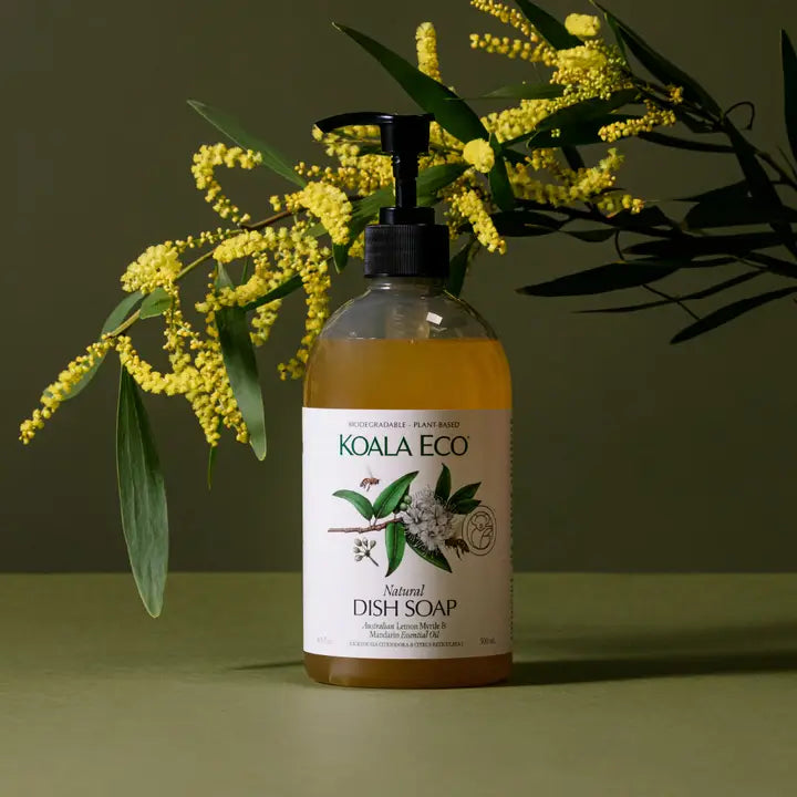 Koala Eco natural dish soap bottle with yellow flowers on a green background