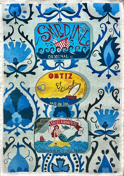 Linen tea towels with cans of sardines on blue background