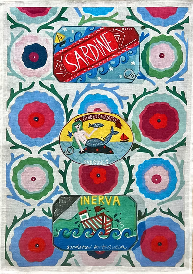 Linen tea towels with cans of sardines on  colourful background