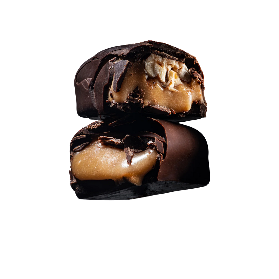 Close-up of a Loco Love chocolate-covered caramel &amp; pecans with a white background