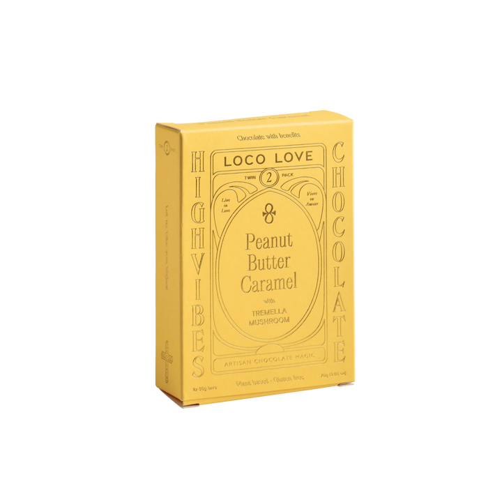Yellow packaging of High Vibes Loco Love Peanut Butter Caramel chocolate on a white background