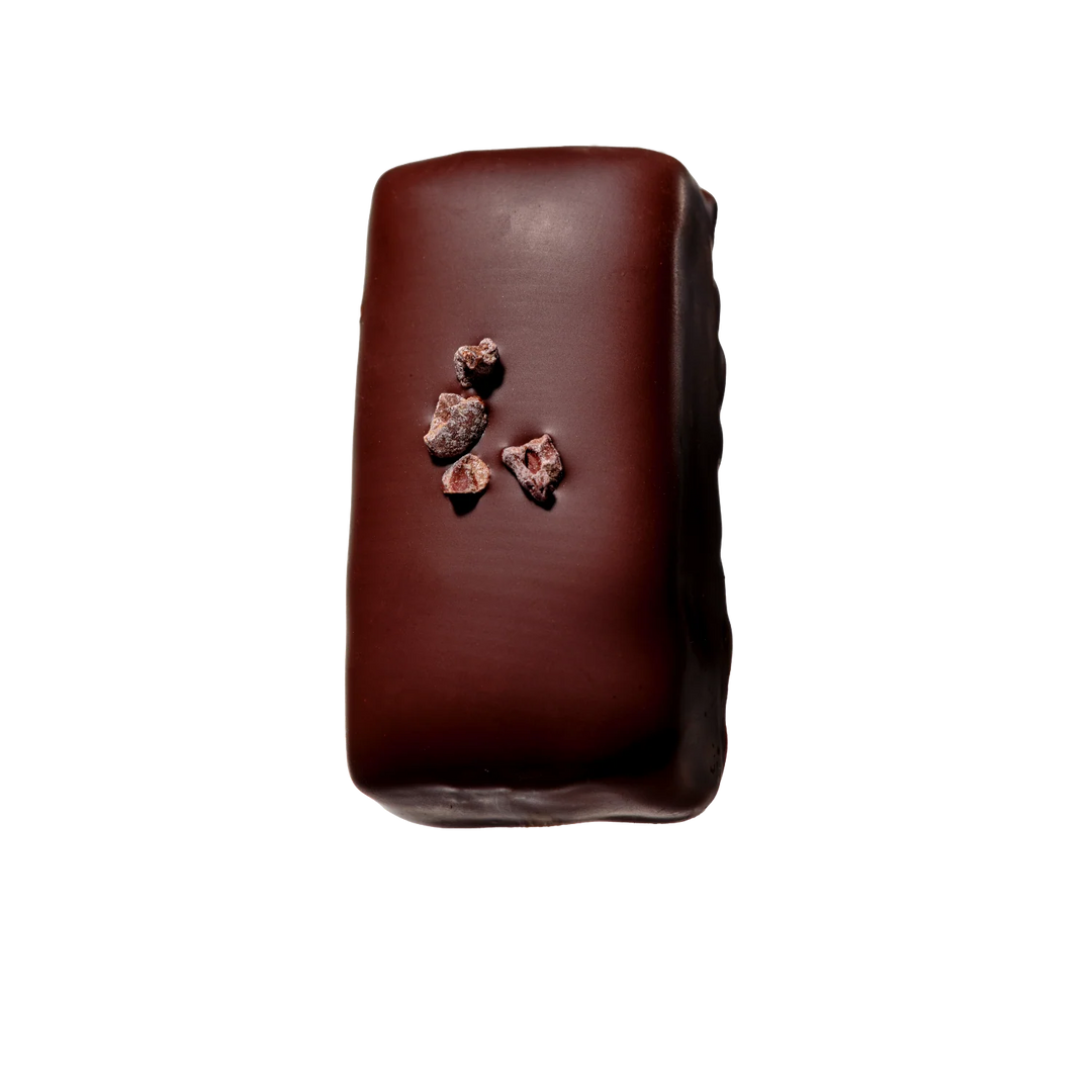 Dark chocolate bar with chocolate pieces on a white background