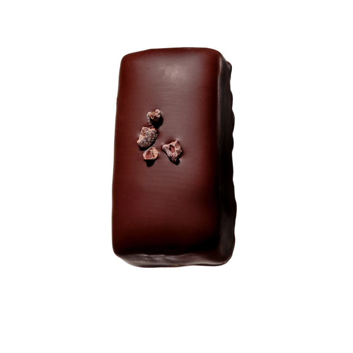 Dark chocolate bar with chocolate pieces on a white background
