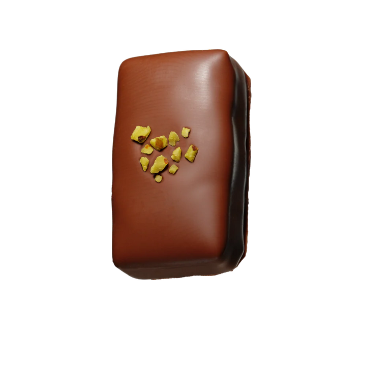 Loco Love chocolate with pistachio toppings on a white background