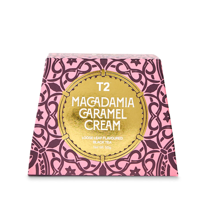 T2 Macadamia Caramel Cream tea box with pink and gold design on a white background