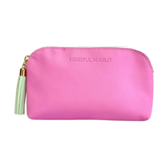 A bright pink zippered pouch with a light green tassel zipper pull and gold-tone hardware, featuring the brand name &