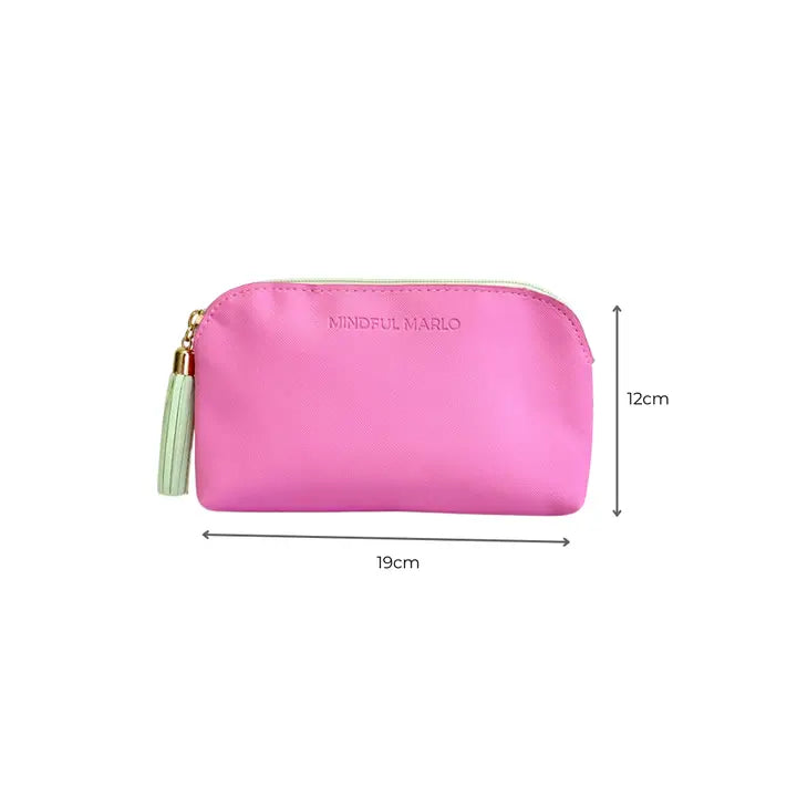 A pink zippered pouch with a tassel zipper pull and debossed &
