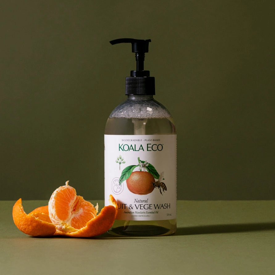 Koala Eco bottle of fruit and veggie wash with an orange on a green background