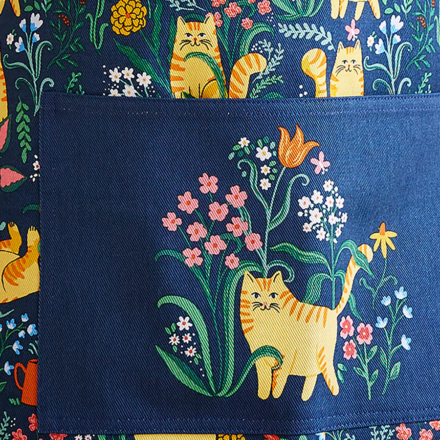 Apron with cat and floral design on a blue background