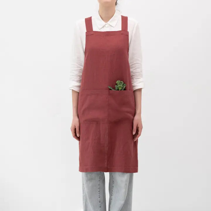Person wearing a red apron on a white background