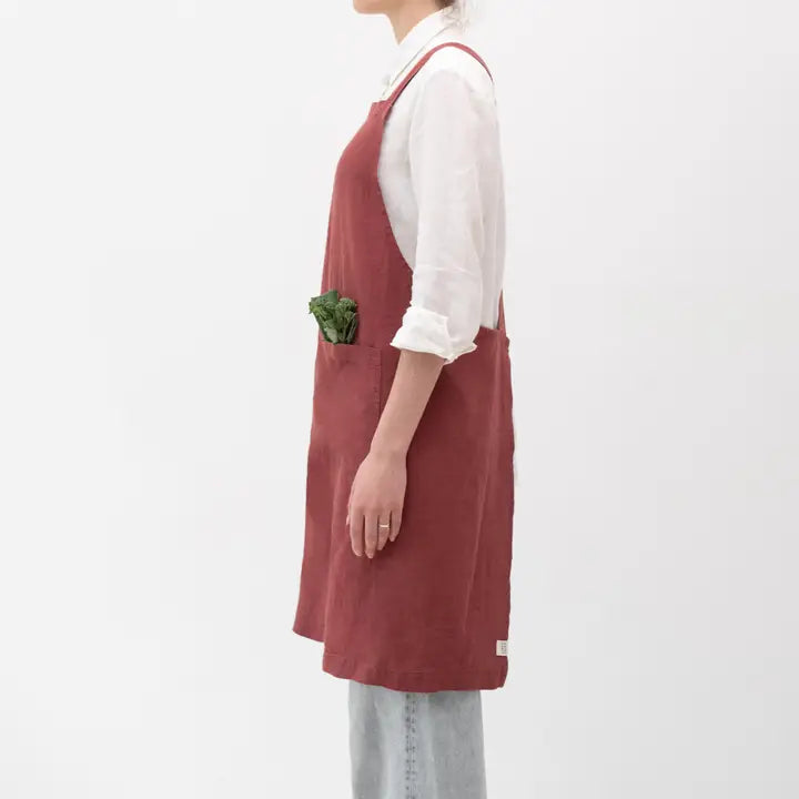 Person wearing a red apron on a white background