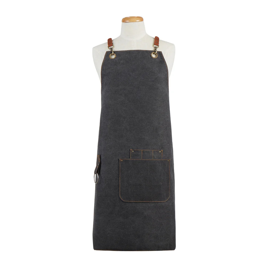 A dark gray canvas apron with brown leather straps and a front utility pocket, displayed on a white mannequin torso against a plain white background.