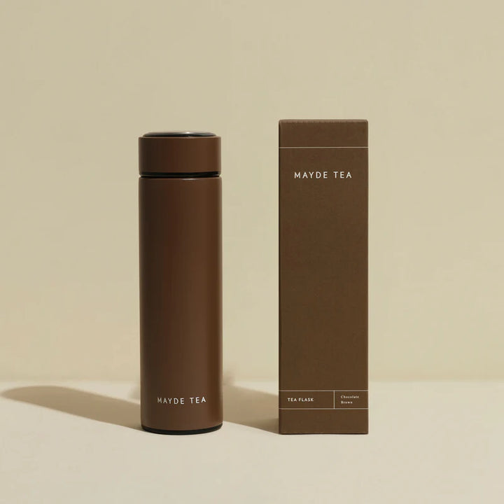 Brown tea flask and packaging with 'Mayde Tea' branding on a beige background