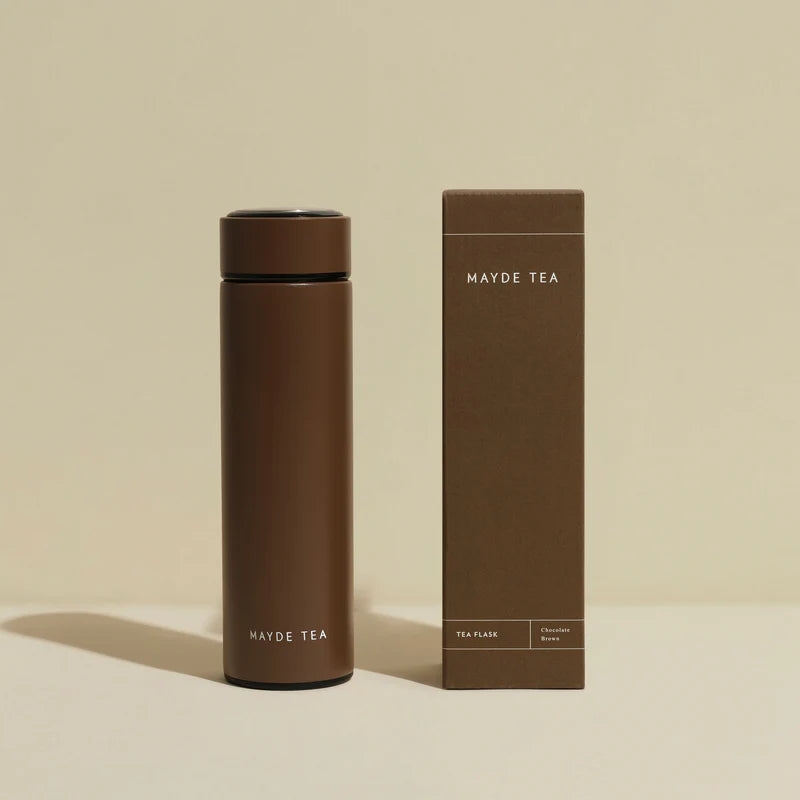 Brown tea flask and packaging with 'Mayde Tea' branding on a beige background