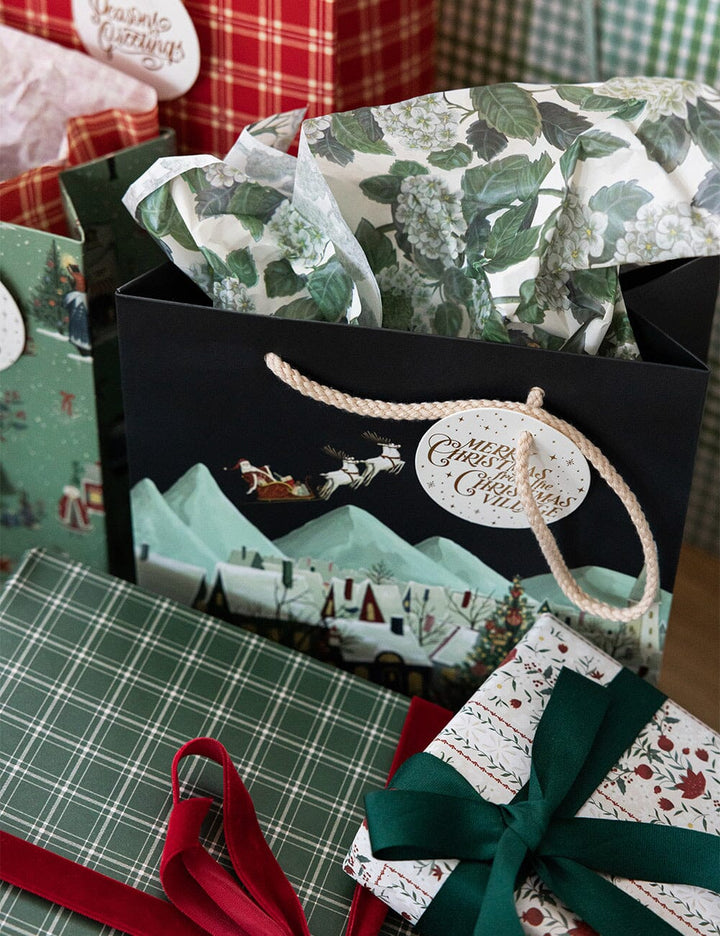 Gift bag with festive patterns and ribbons on a checkered surface