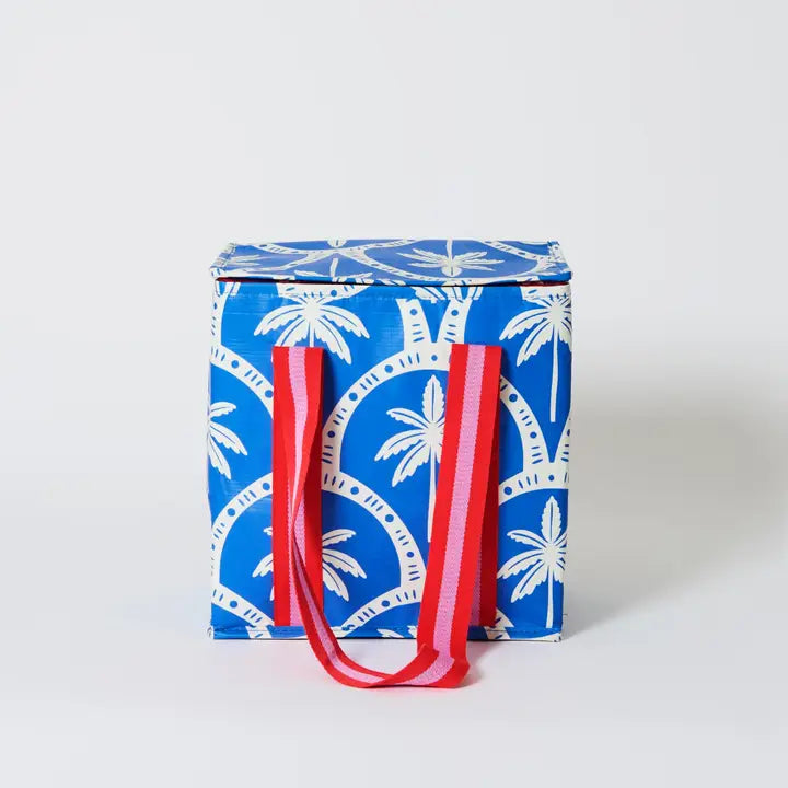 Blue & white insulated tote bag with red & pink handle on a white background