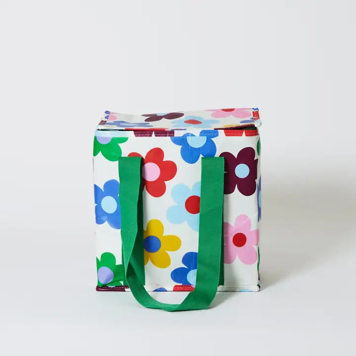 Colorful floral-patterned cooler bag with green handles on a white background