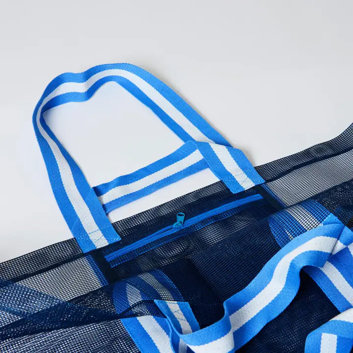 Blue and white striped bag with mesh pocket on a light gray background