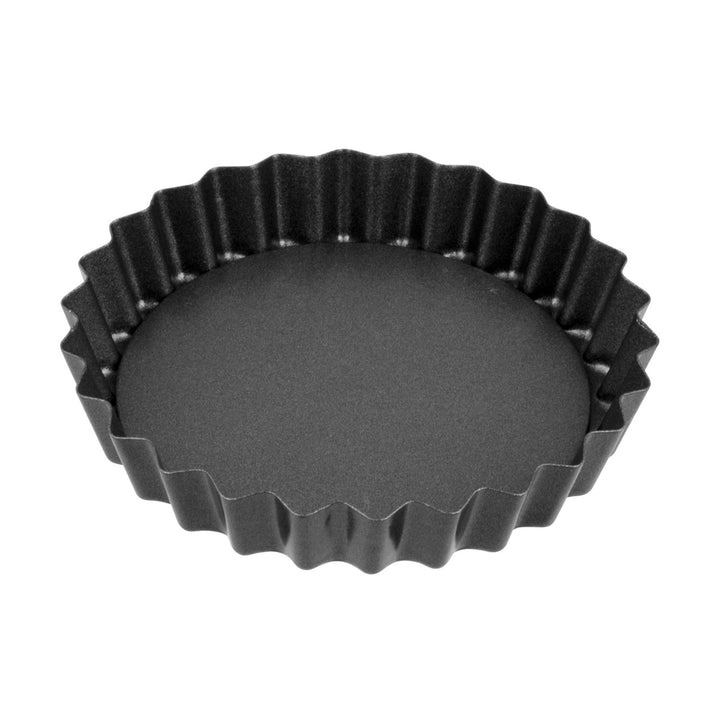 Black fluted tart pan on a white background