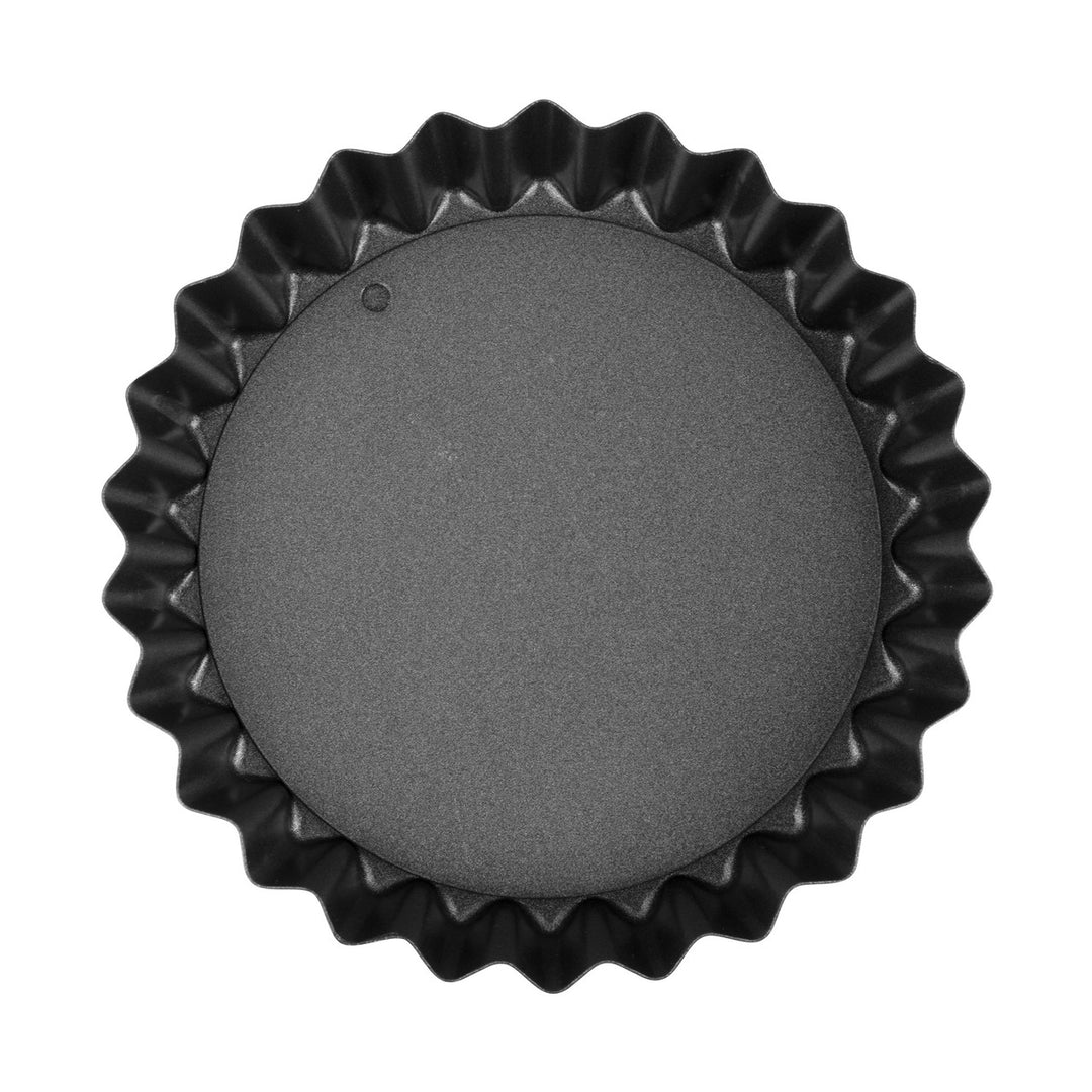 Black fluted tart pan on a white background