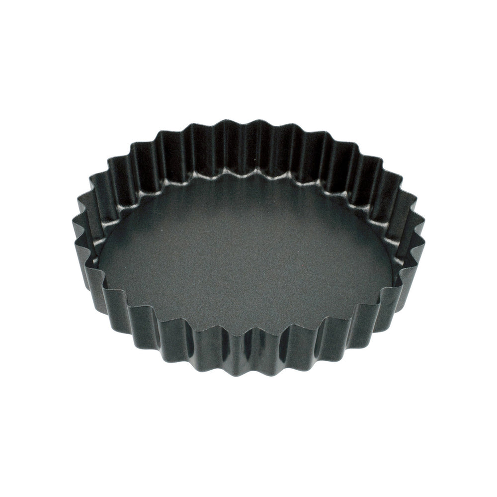 Black fluted tart pan on a white background
