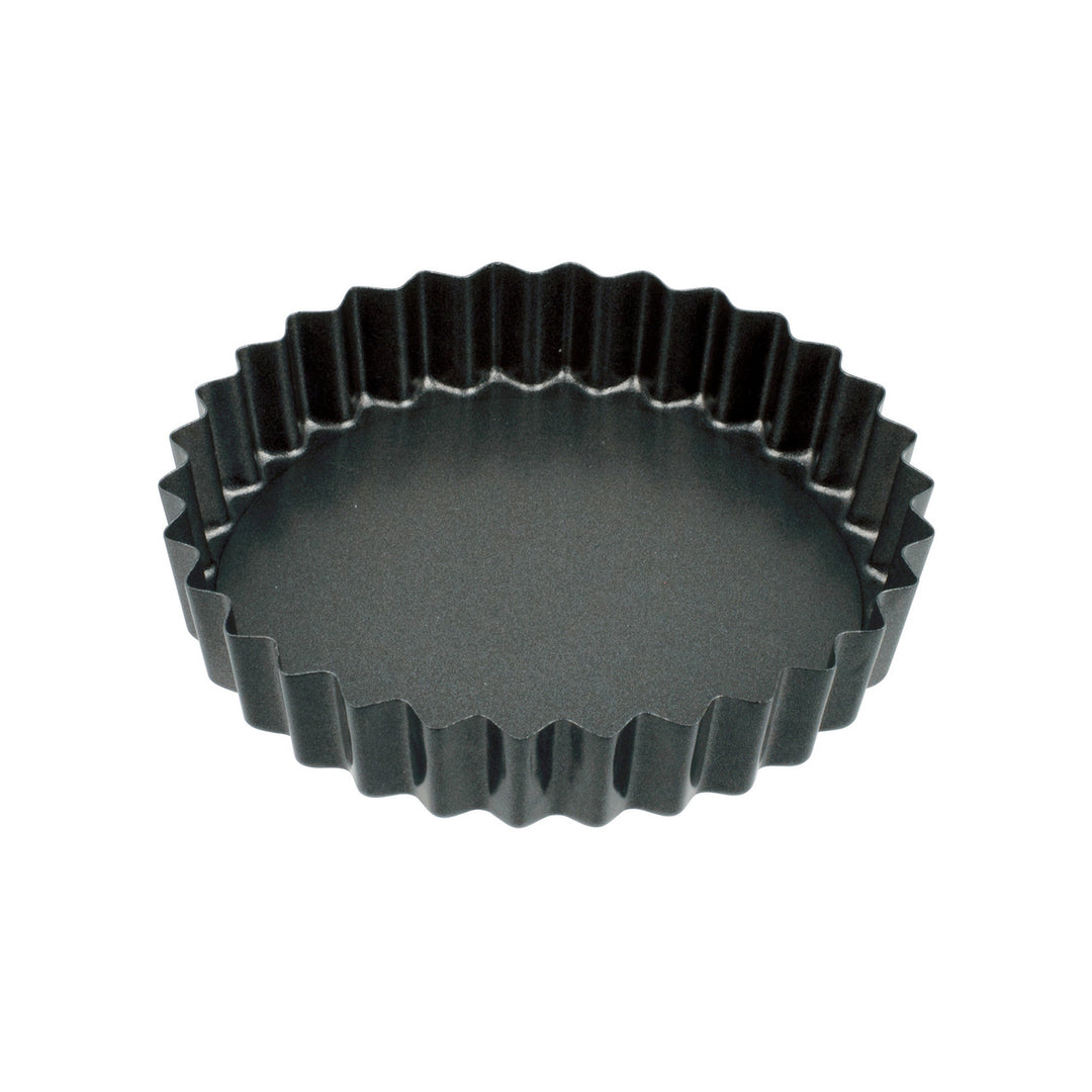 Black fluted tart pan on a white background