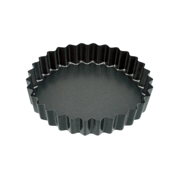 Black fluted tart pan on a white background